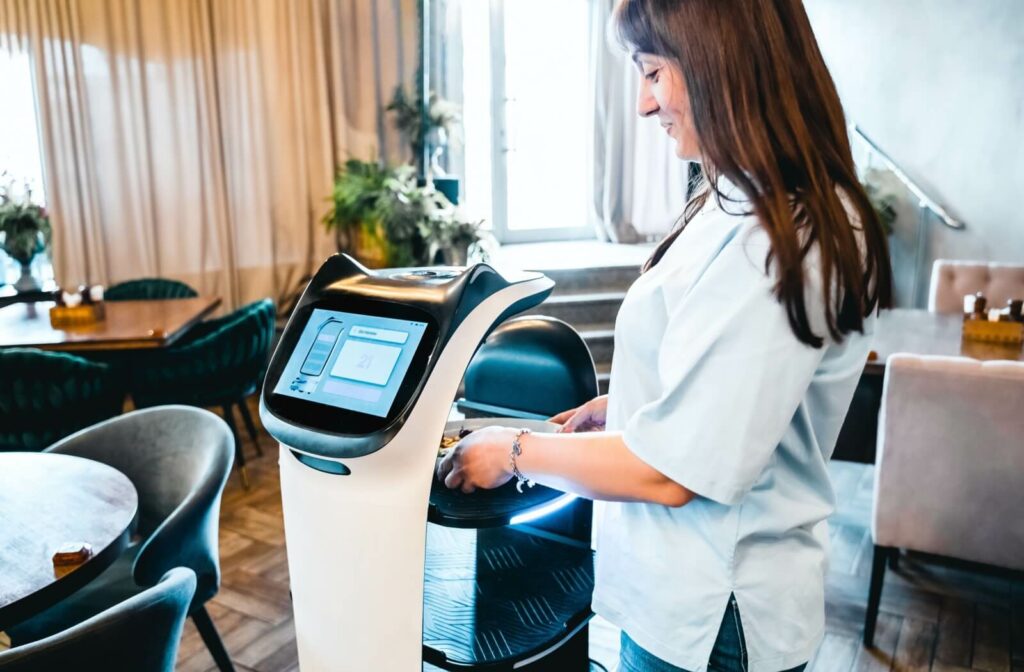 Juniper team member using a Servi robotic porter.